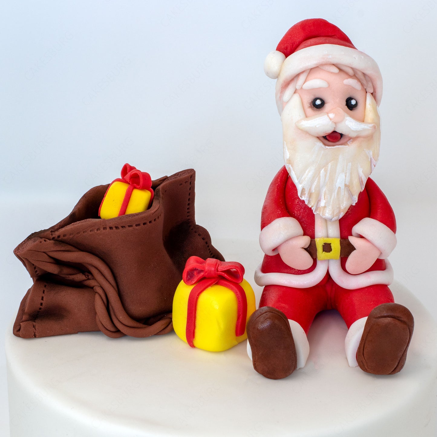 Edible Fondant Sitting Santa Clause with Gift Bag Cake Topper